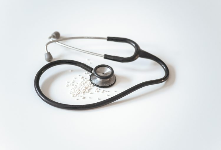 stethoscope and non-descript homeopathic pellets